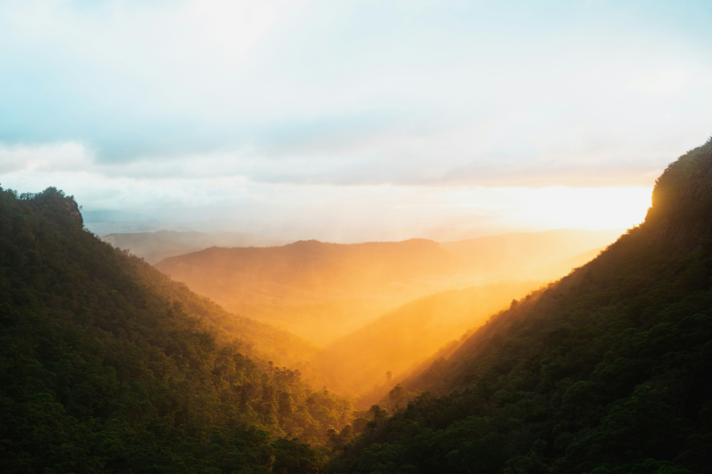 Sun rays shining through mountain valley, photo by Caleb on Unsplash for a blog post about intentional learning.
